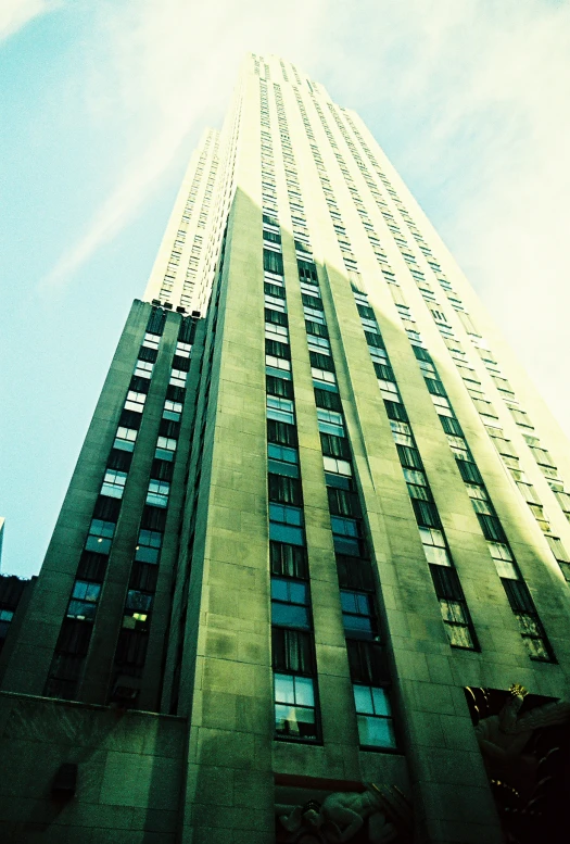 a tall skyscr with many windows next to blue sky