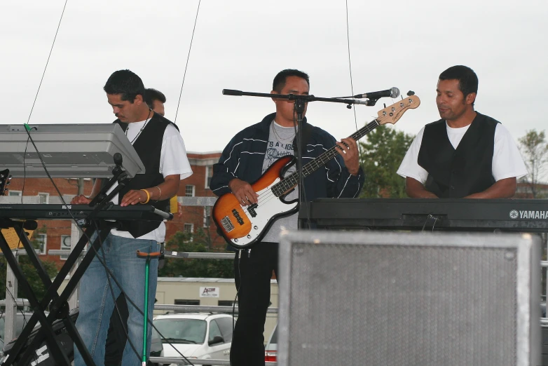 several men with guitars on a stage