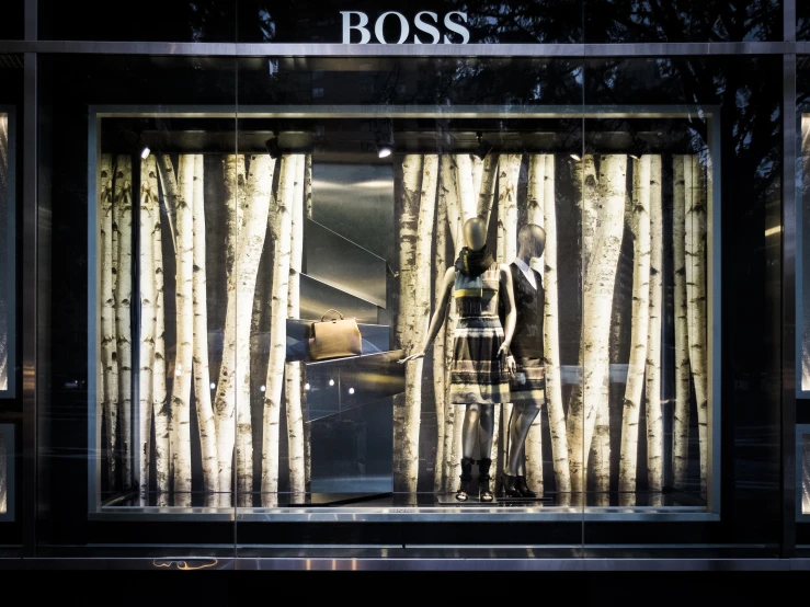 the window of a business displaying the glass of the store's front with trees and an open umbrella