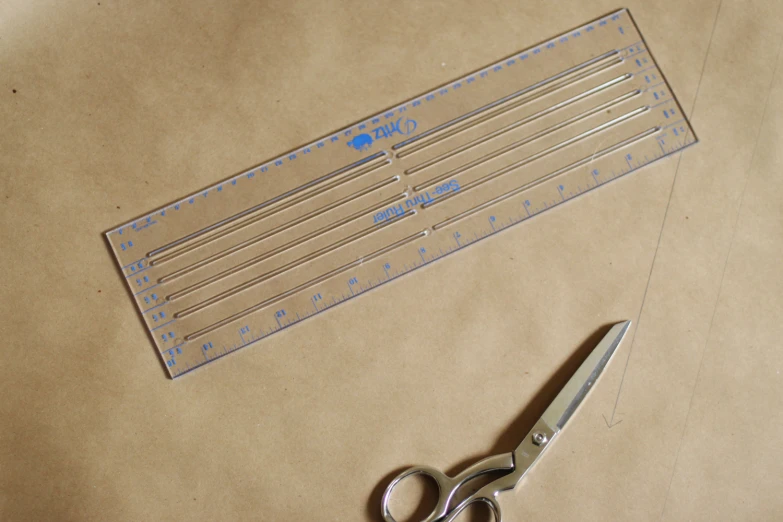 scissors and rulers on a brown surface