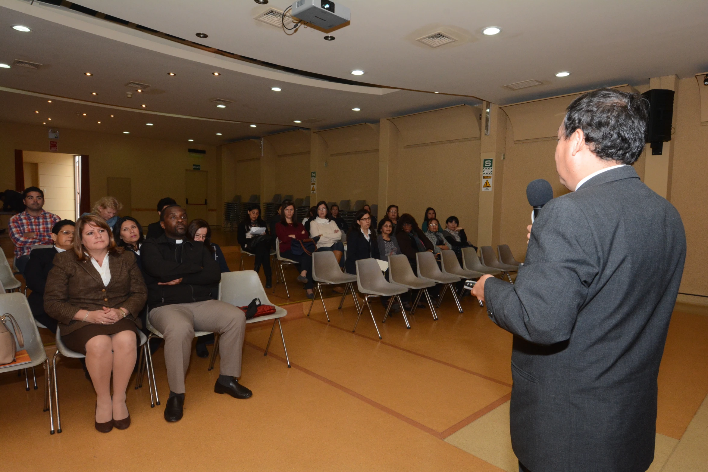 the man is giving a talk to an audience