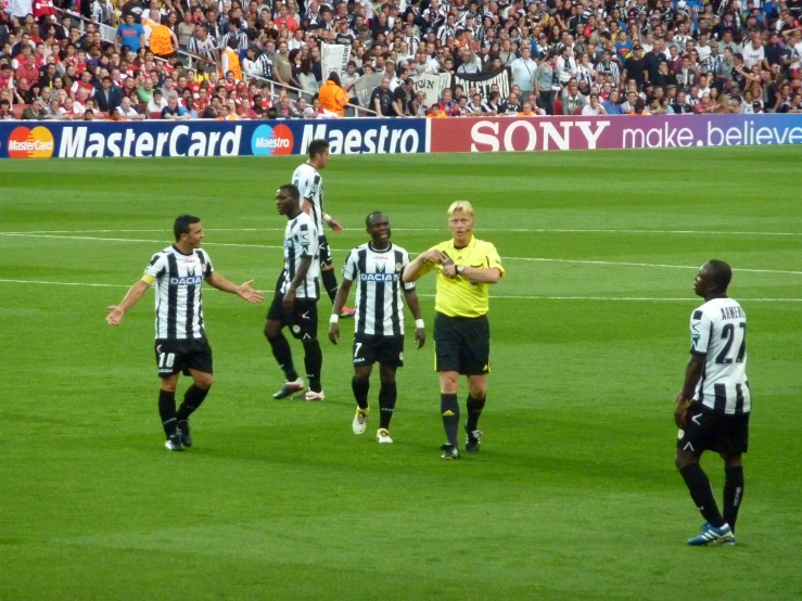 a bunch of people that are playing soccer on a field