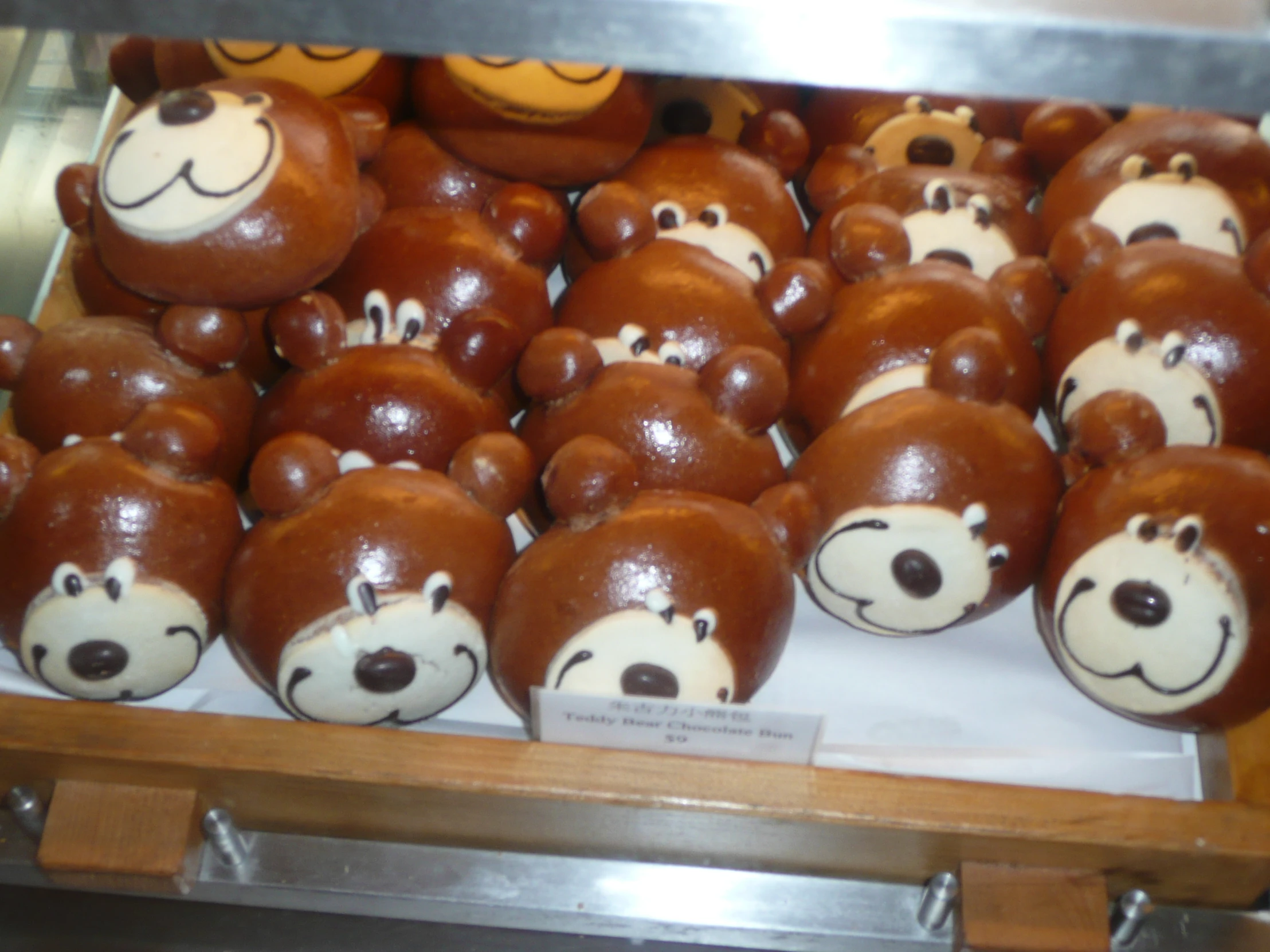 many brown and white teddy bears on display for sale