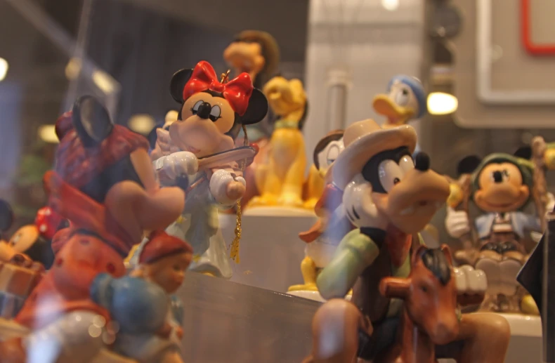 a close up of a small figurine in front of a display window