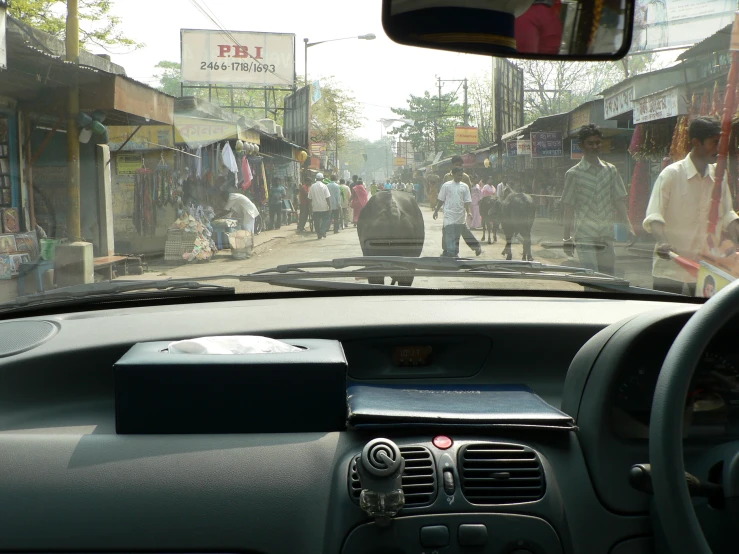 a busy street in india as seen from the dashboard of a car