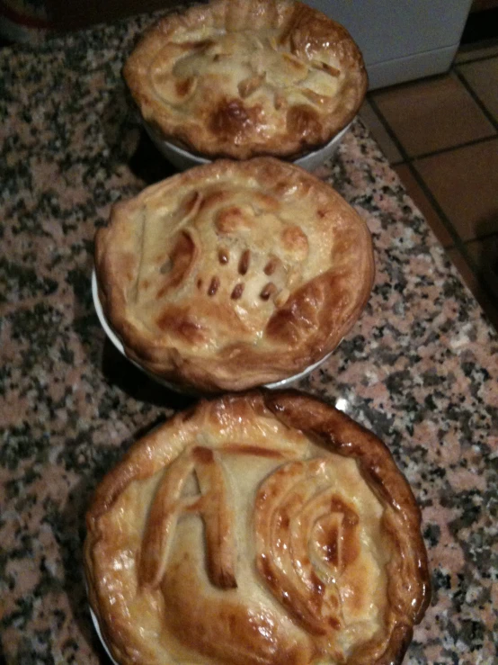 four individual pies with different flavors on top