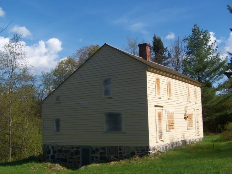 an old house sitting on top of a lush green field