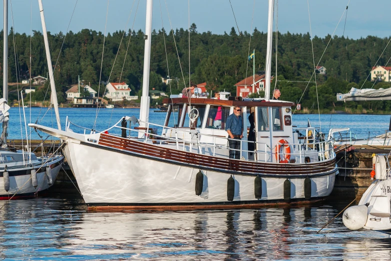 several boats are docked in a harbor near some buildings