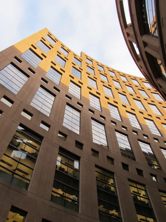 an upward view of a building on a sunny day