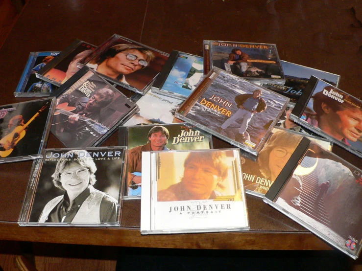 various cd's lined up on a table with one person playing