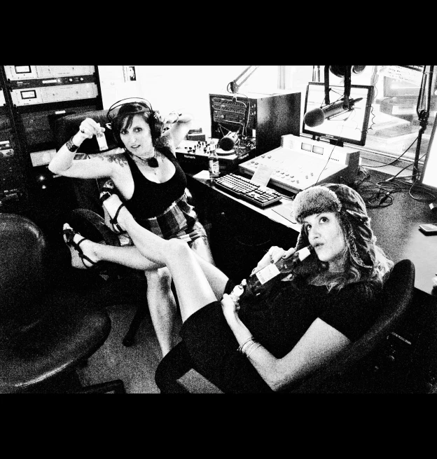 two women sitting next to each other in an office