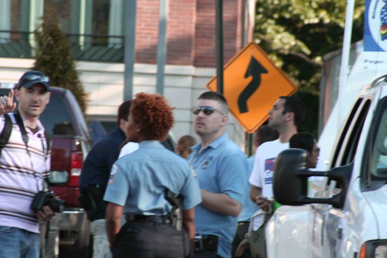 a group of police standing around and facing the side