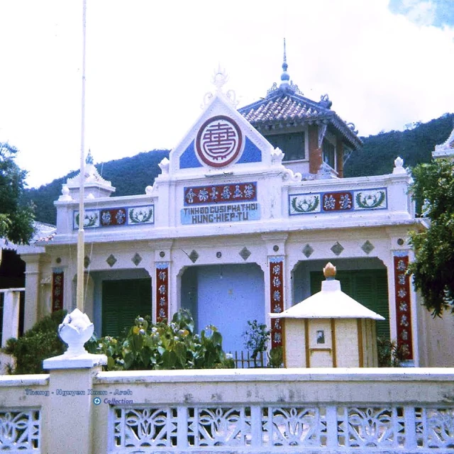 a building with a garden and a white fence