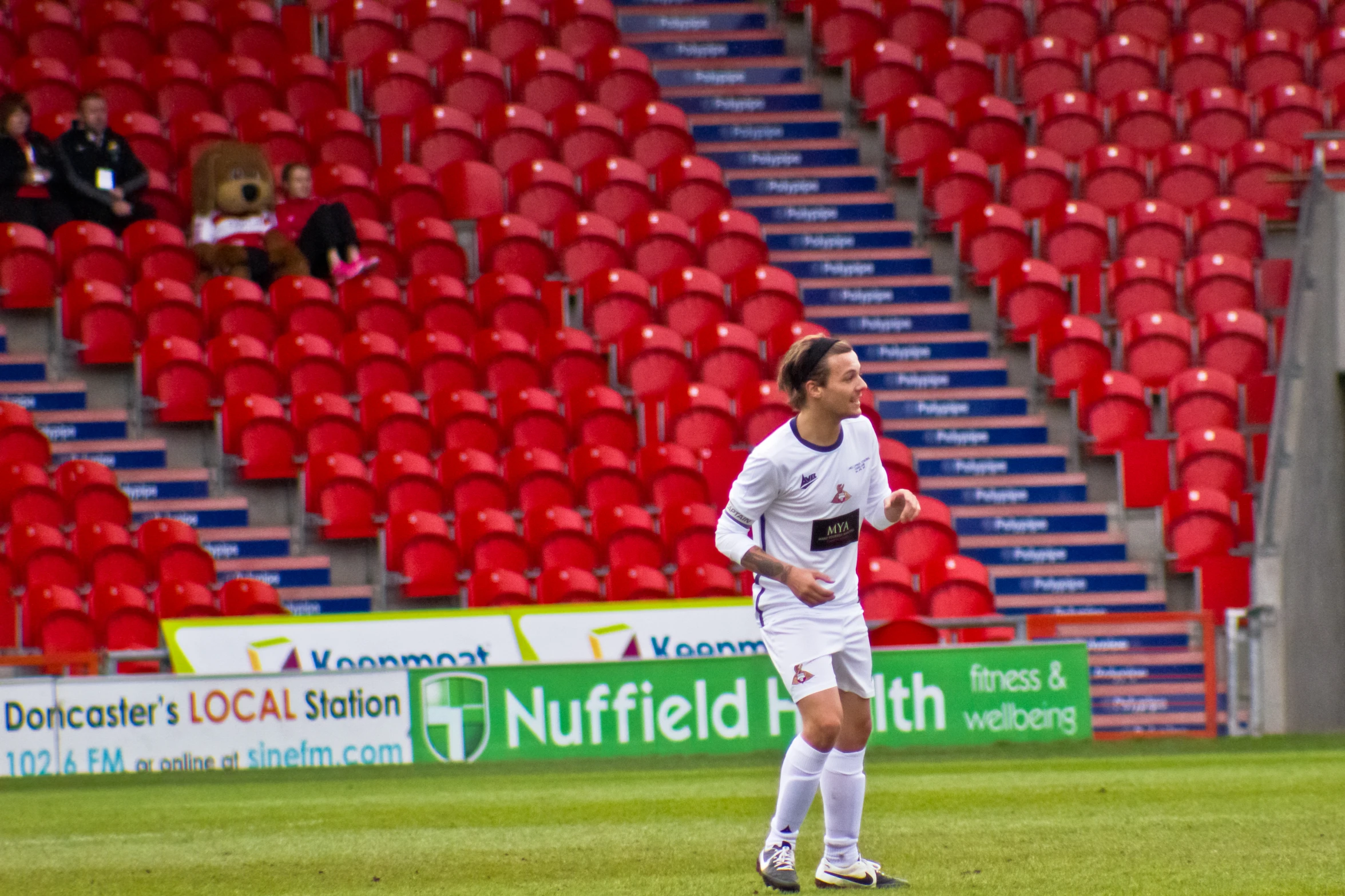 there is a male soccer player standing on the field