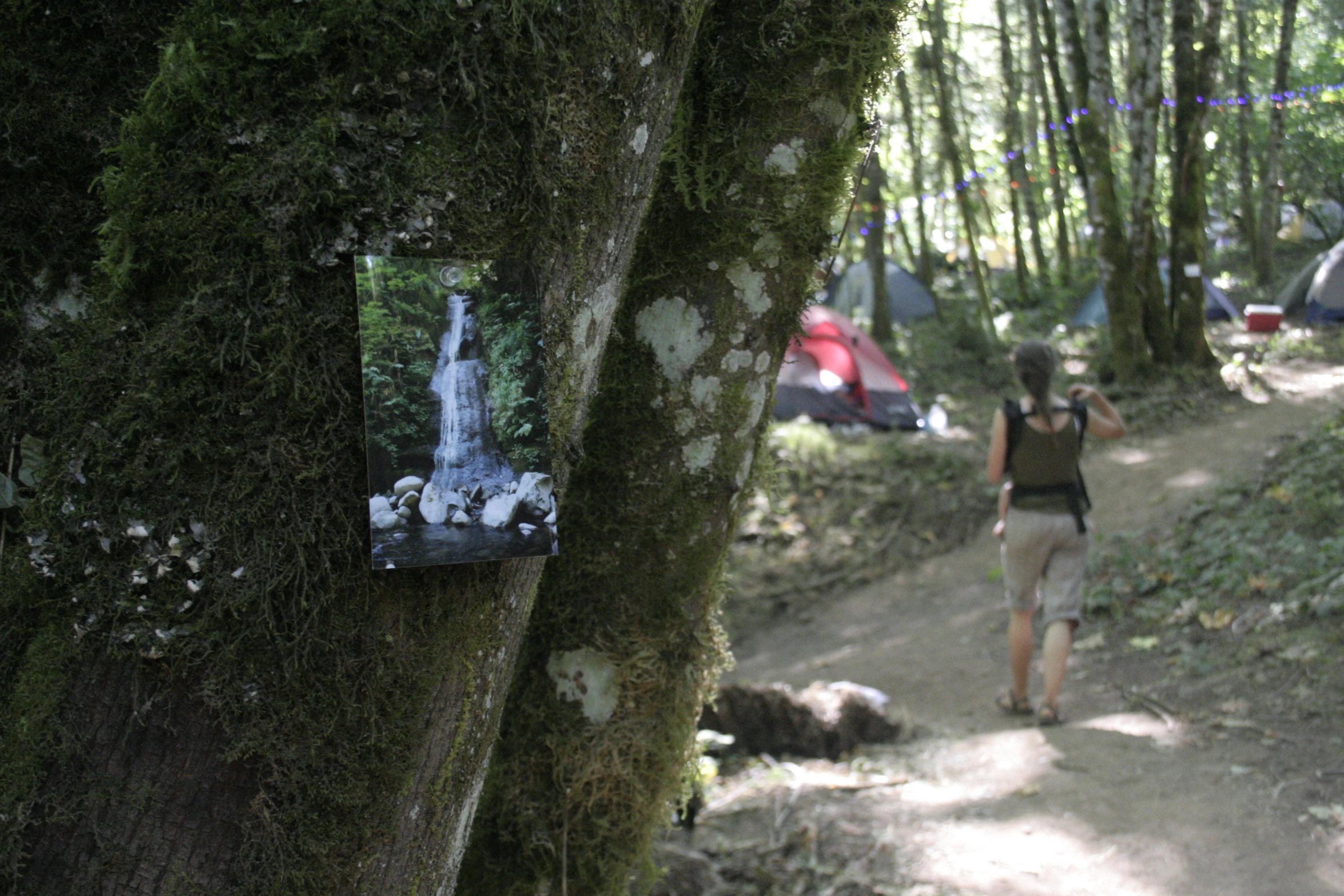 a person on a trail with a mirror in the background