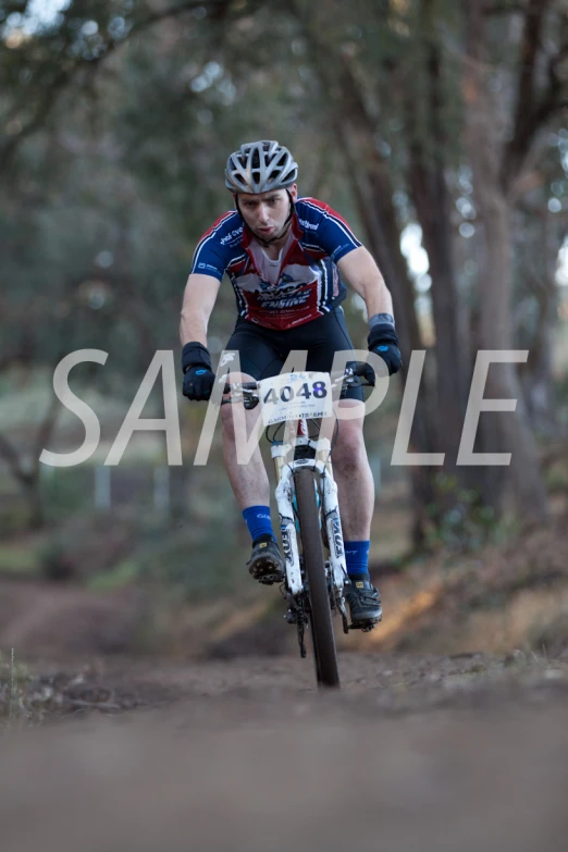 a man riding a bike through a dirt field