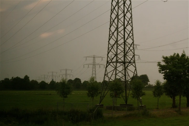 power lines are rising above a green landscape