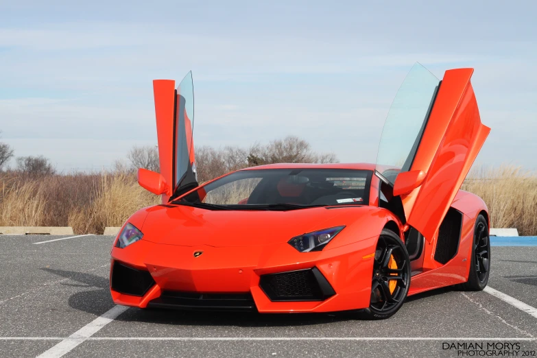 an orange sports car that is open and looking very nice