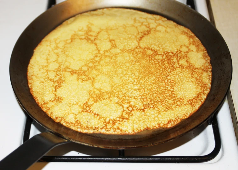 a pan with soing on top of it on a stove