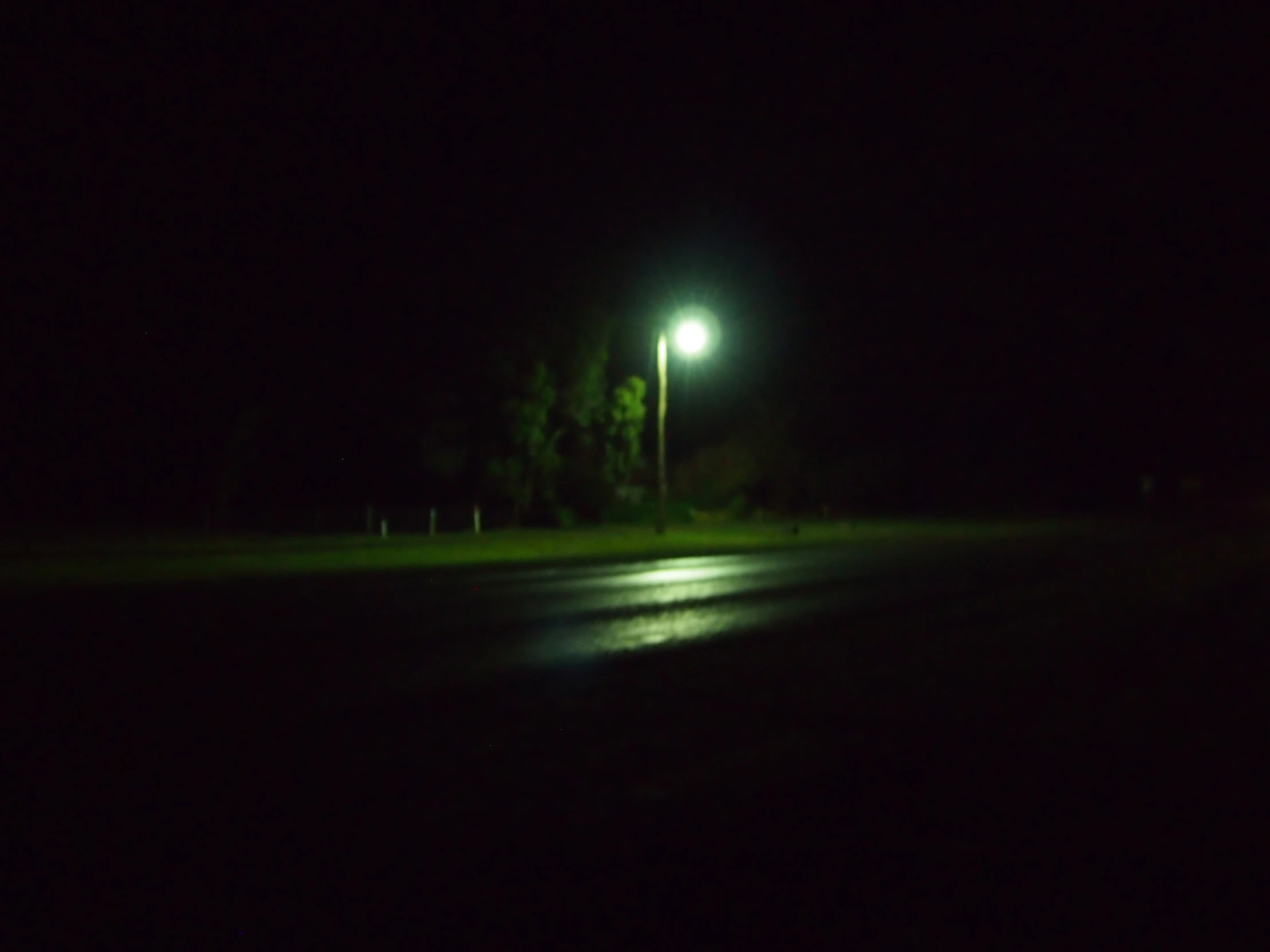 a street at night with a bright street light on