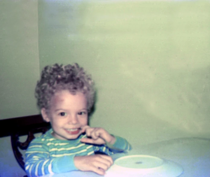 a  sitting at a table eating food