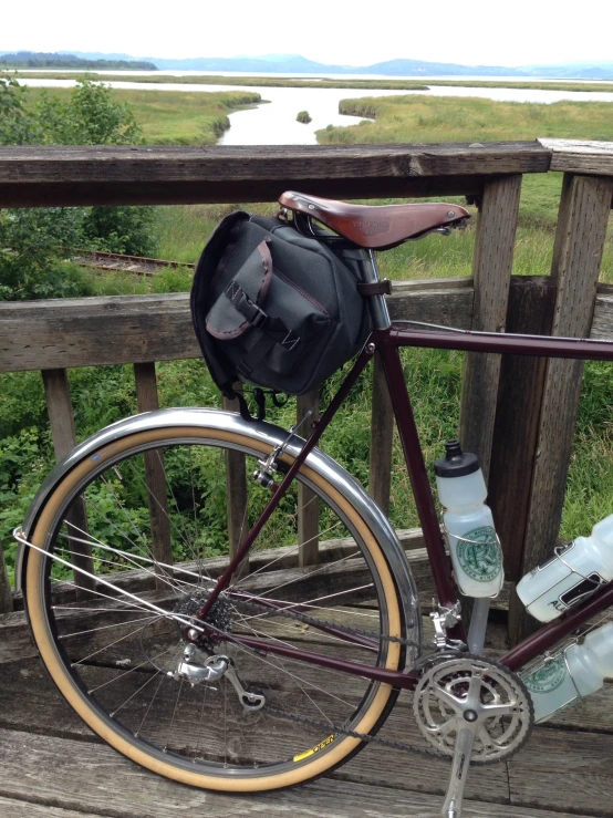 the back of a bike has a small bag on it