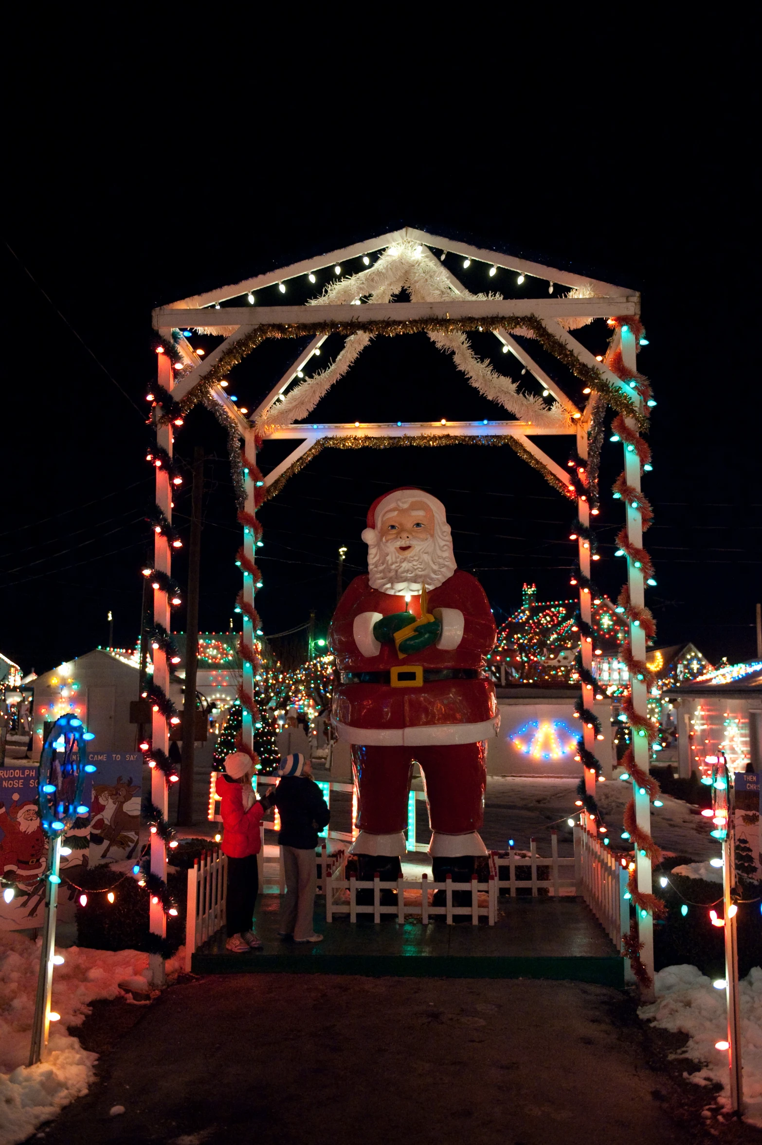 a santa clause decorated over the top of a gazebo