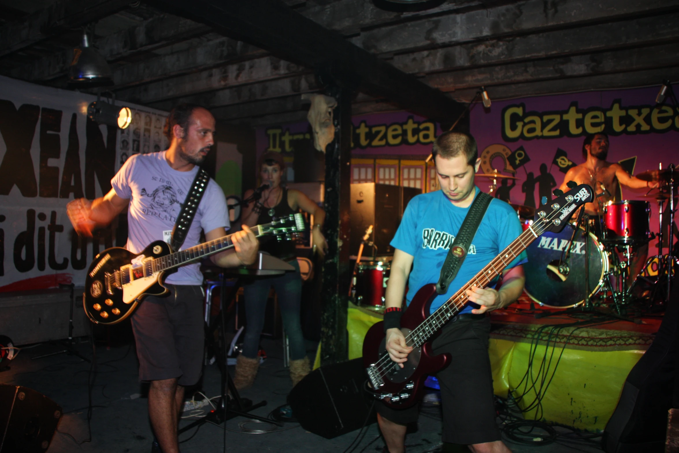 a group of men playing guitar together in a room