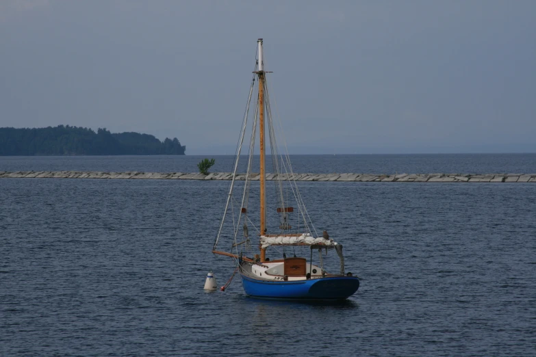 a large blue and white boat floating on top of water