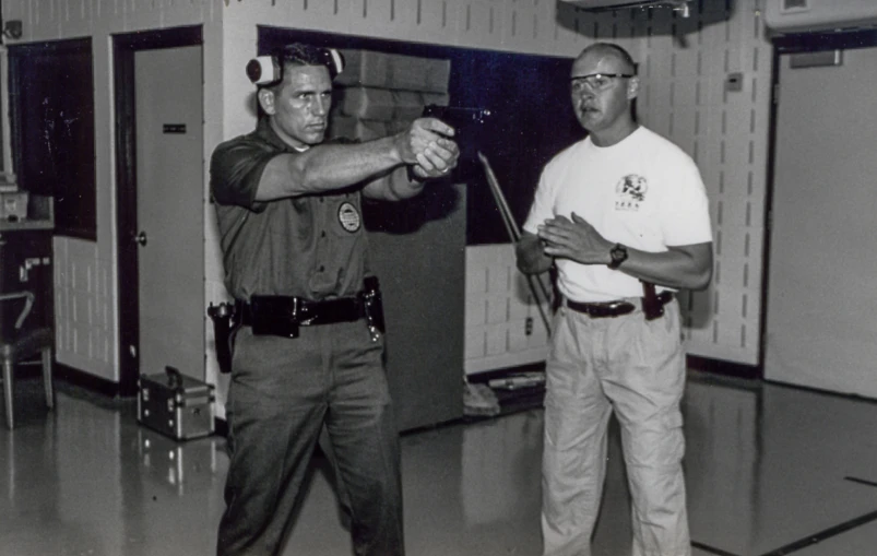 two men standing on a hall holding knives