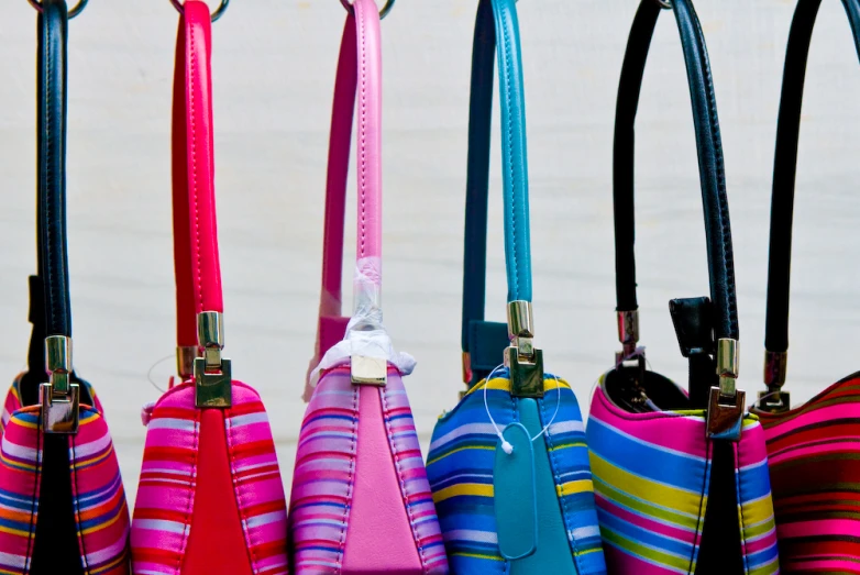 a group of purses lined up on display