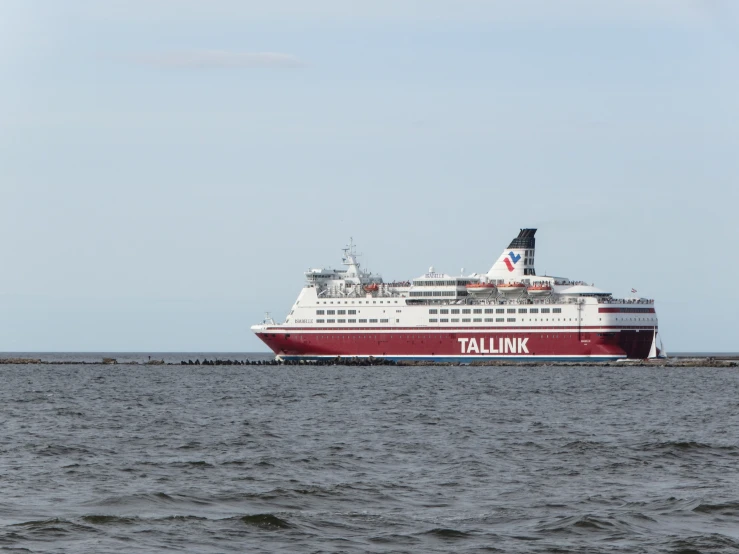 a large boat traveling through the ocean on a clear day