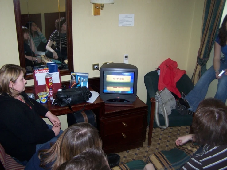 a group of women in a room watching tv