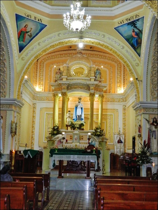 a church with a decorated alter and stained glass ceiling