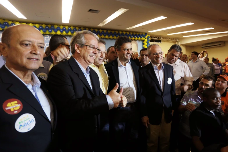 a group of people standing and clapping at an event