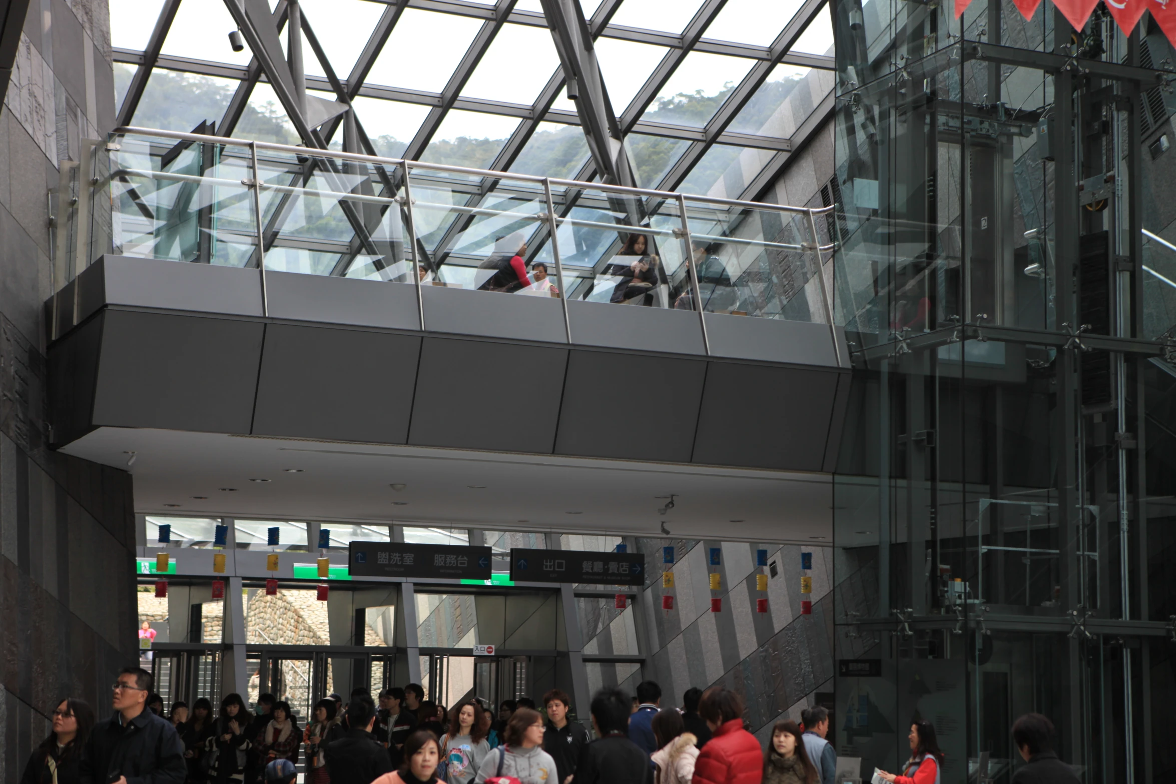 the people are waiting to go up the glass staircase