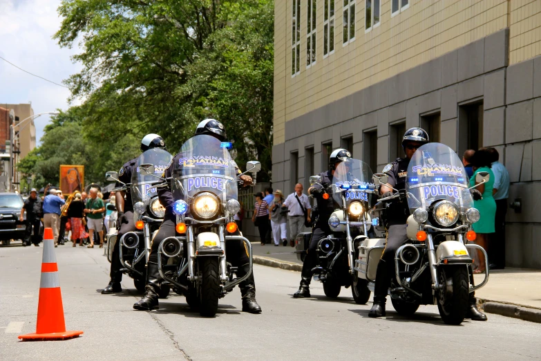 a group of police officers riding motorcycles down a street