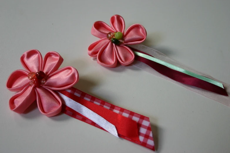 two matching pink flower bobbyies with ribbon