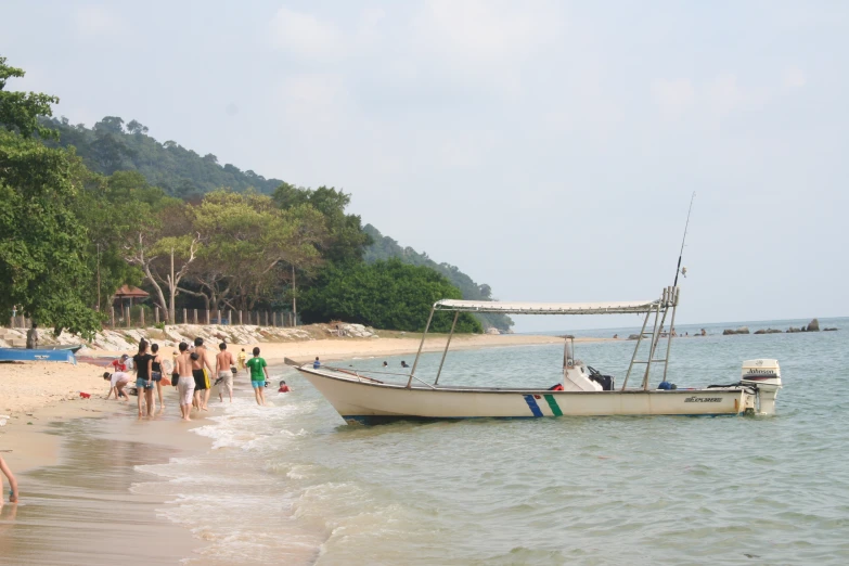 a small boat docked on the shore of a beach