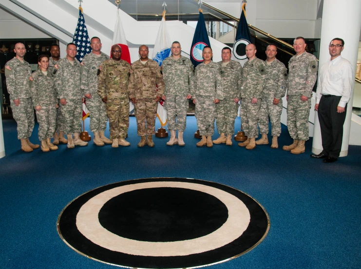 people in military uniforms pose for a group po