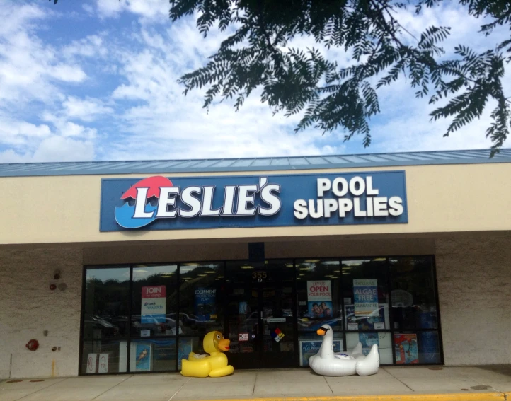 an outside store with fake rubber ducks in front of the store