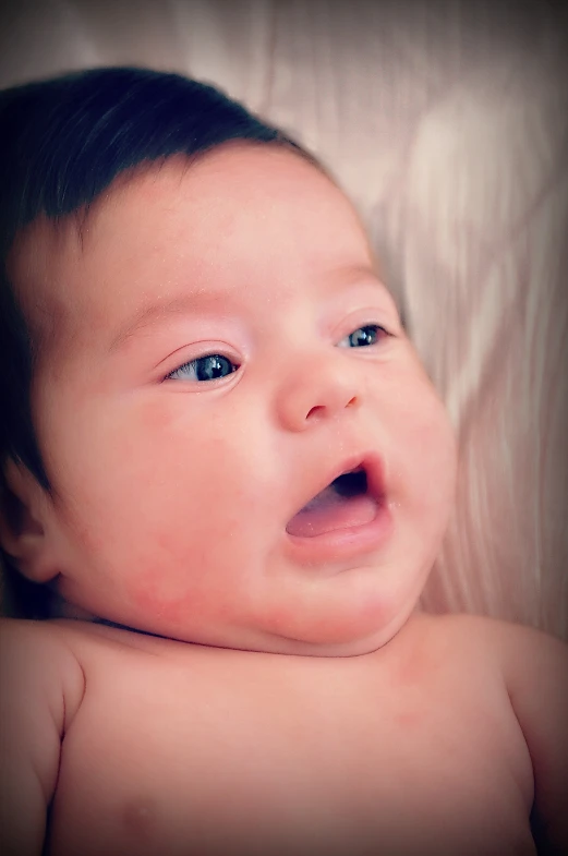 a young child that is laying down looking up