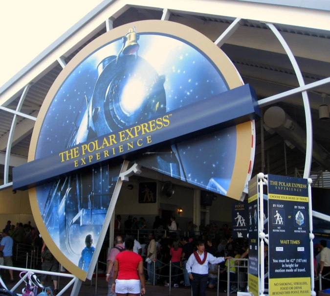 a man walking in front of the entrance to a theater