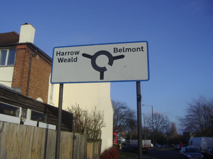 there is a street sign pointing towards a town