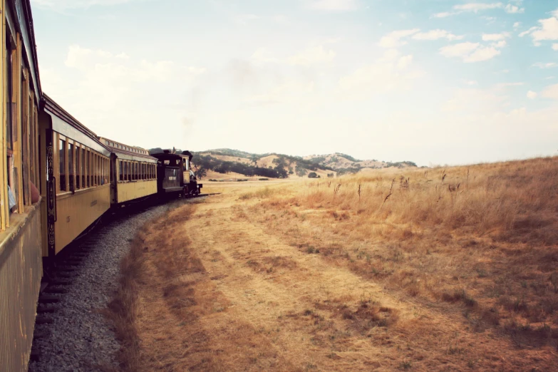 a small passenger train is traveling on the tracks