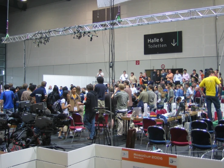 a large group of people are standing around at a convention