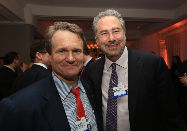 two men who are dressed up and smiling for the camera