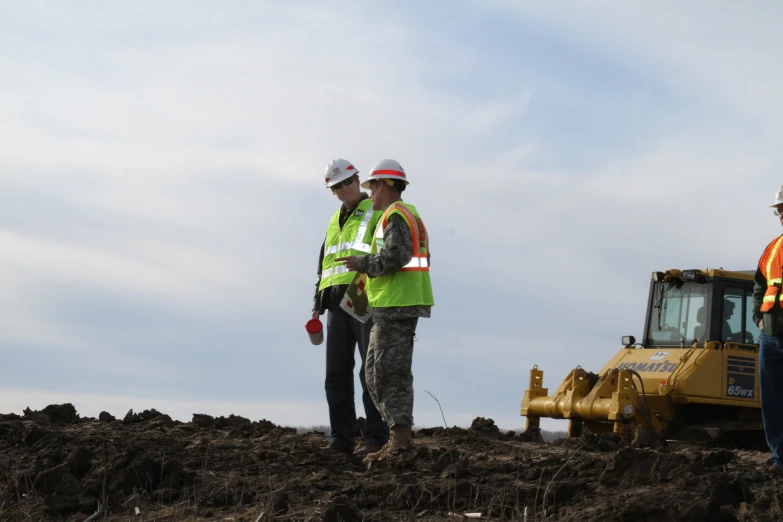 two men wearing hard hats and safety vests