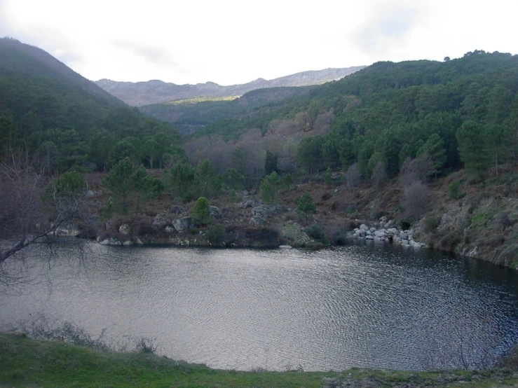 a lake is shown surrounded by mountains