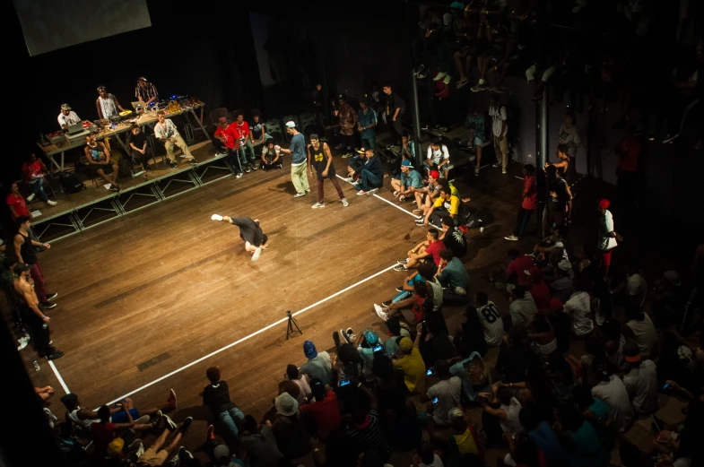 a man on a stage with people in the stands